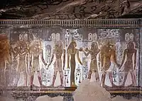 Section of tomb showing wear and tear of graffiti, along with depiction of Seti I with Hathor, Horus, Isis, and Anubis. Theban Mapping Project.