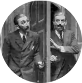 two men peering cautiously at each other from either side of a door