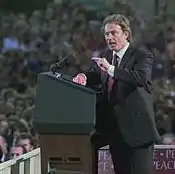 A man on a podium addressing a crowd