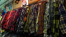Clothing rack with very wide array of tartan flannel shirts