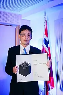 Japanese man with glasses and diploma