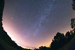 A full sky view (moon on left) shows the Milky Way (across the center), which is usually invisible under a full moon.