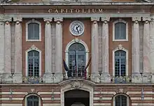 Three flags tied up in front of the Capitole
