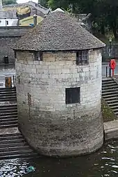 a circular stone tower with a conical roof