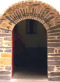 Church door with inscription La porte est en dedans ("The door is within")