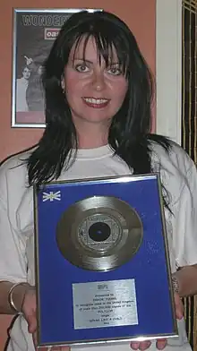 Young with her BPI silver disc for "Speak Like a Child" which she auctioned to raise money for Little Havens Children's Hospice in 2007.