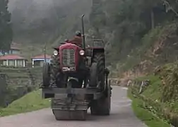 A road-roller powered by a tractor mounted on it