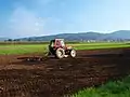 A tractor pulling a chisel plow in Slovenia