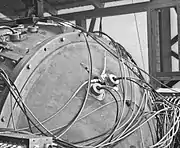 Closeup of a detonator set.  The EBW is the Y-shaped device with two wires coming in at angles along the surface.  The larger round objects with two wires coming out perpendicular to the surface are diagnostic equipment.