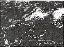 Satellite image of a poorly defined, dissipating tropical cyclone over North Carolina. The image shows a large portion of the United States east of the Rockies and part of Mexico as well as southern Canada. Another, better defined cyclone is visible on the right side of the image.