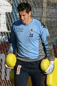 Tschauner holding weights and wearing his football gear