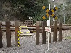 To reach the nearest main road, it is necessary to cross the tracks at this level crossing and then climb up a mountain path.