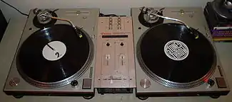 Two vinyl turntables and a small mixer
