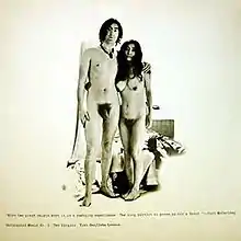 Jon Lennon and Yoko Ono frontally nude, Lennon’s arm around Ono. The couple are in the center of the cover, which is mostly blank off-white except for some small text.