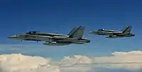 Two Royal Canadian Air Force CF-188 Hornets approach a Colombian A.F. KC-767 tanker
