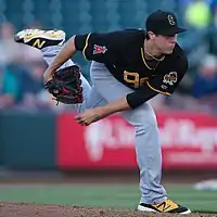 photo of a man following through after throwing a pitch