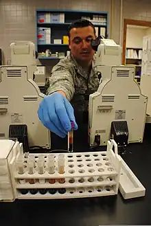 A U.S Air Force staff member, who is a medical laboratory technician doing blood samples.