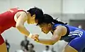 U.S. Army World Class Athlete Program wrestler Sgt. Iris Smith (right) defeats China's Lijun Yang 1-1, 0–1, 3-0 en route to winning the gold medal in the women's 72-kilogram/158.5-pound freestyle division 14 Aug. at the 27th World Military Wrestling Championships in Lahti, Finland.