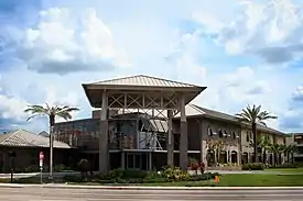 A glass-clad and brick exterior of a modern-style, two-story building