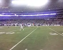 Two football teams on the field in position prior to the play