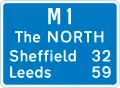 Route number of the motorway with destinations and distances to places along or reached from that route