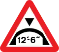 Warning of maximum headroom of arch bridge directly ahead (imperial)