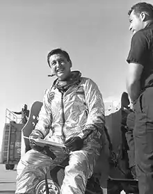 Crossfield in his X-15 flightsuit with checklist in hand