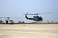 UH-1N Iroquois (Huey) utility helicopter (right) takes off from the flight line at Camp Humphreys.