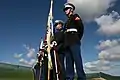 A joint-force color guard waits before the ceremony which marked the official opening.