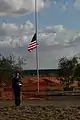 A lone bugler finishes a rendition of "Taps". Dignitaries buried four veterans and one spouse, marking the official opening of the new facility.