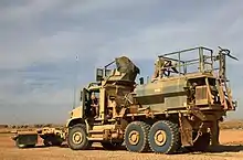 Designation for standard cargo 4.674 m wheelbase MTVRs is MK23 or MK25 (with winch). This example has an armored cab and is equipped with mine rollers