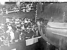 Wood (in white uniform at lower left) attends the christening of the submarine USS O-1, 9 July 1918.
