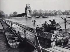 United States Army troops cross the Rhine on a heavy pontoon bridge during Operation Plunder, March 1945