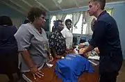 Aboard the Military Sealift Command (MSC) hospital ship, USNS Mercy, YN3 Dan S. Konzek demonstrates how to properly locate the brachial pulse to nurses from the Modilion General Hospital in Madang, Papua, New Guinea. USNS Mercy had just completed tsunami and earthquake relief operations in Indonesia (2005).