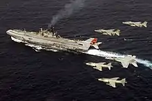 Indian Navy Sea Harriers and Indian Air Force SEPECAT Jaguars with US Navy F/A-18 Super Hornets flying over INS Viraat