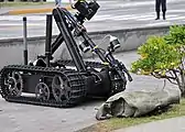 US Navy 090512-N-2013O-013 A Mark II Talon robot from Explosive Ordnance Disposal Mobile Unit 5, Det. Japan, is used to inspect a suspicious package during a force protection-anti-terrorism training exercise