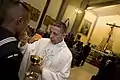 Navy Catholic Chaplain Cmdr. Alfonso Concha distributes Holy Communion