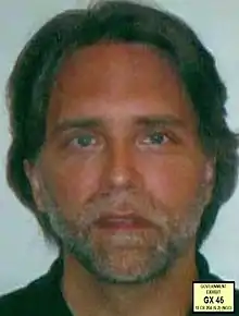 Raniere posing for a mugshot