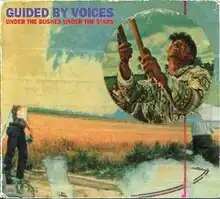 A fairly surreal, impressionistic collage whose main focus is a circular cut-out of a man holding two sticks and looking up. The band name and album cover appear in a bold font in the upper left corner.