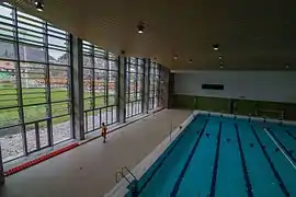Indoor pool with outdoor playing field