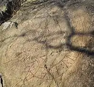 Rune carving, Riksbyhällen, on the cliff, U59, has a simpler carving.
