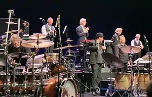King Crimson at the Sapporo Culture Arts Theatre in Japan, on December 2, 2018. From left to right: Pat Mastelotto, Tony Levin, Bill Rieflin, Jeremy Stacey, Jakko Jakszyk, Gavin Harrison and Robert Fripp (Mel Collins not shown)
