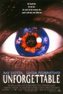 Closeup image of an eye, the iris is blue and flecked with red, an image of a man holding a gun is can be seen in the iris, the face of another man is reflected in the dark pupil