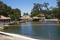 A set with a pond in the middle and houses and boats surrounding it