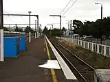 Upper Hutt railway station dock platform terminus (at buffer) in front of the railway station building. The blue boxes on the platform are cycle storage lockers.