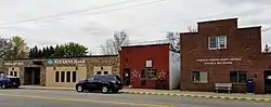 brick and wood buildings along a two-lane highway