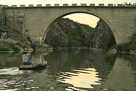 A boat at the mouth of the Fshajt Bridge and the canyon