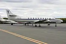 An aircraft with wheels lowered, descending for landing