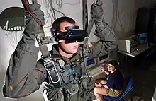 Image 10U.S. Navy Hospital Corpsman demonstrating a VR parachute simulator at the Naval Survival Training Institute in 2006 (from Virtual reality)