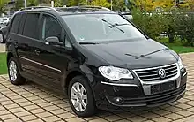 Front-three-quarter view of a Touran with some chrome trim and tinted rear windows